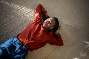 Black Woman Relaxing On Mold Free Carpet After Cleaning Service Resized